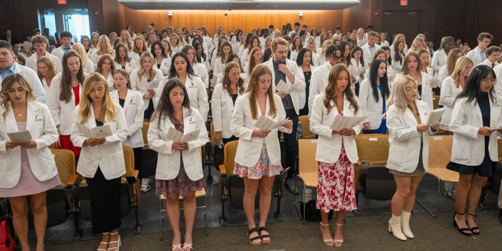 Nursing students reading at the White Coat ceremony